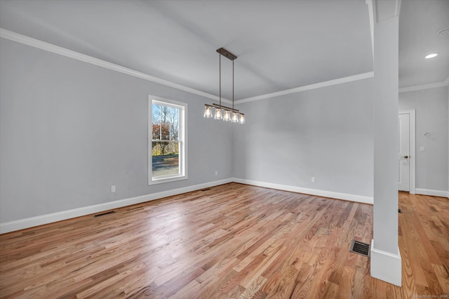 unfurnished dining area featuring light wood-type flooring and crown molding