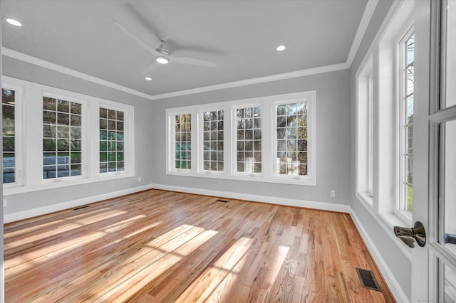 unfurnished sunroom with ceiling fan