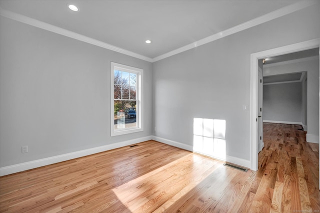 unfurnished room featuring light wood-type flooring and ornamental molding