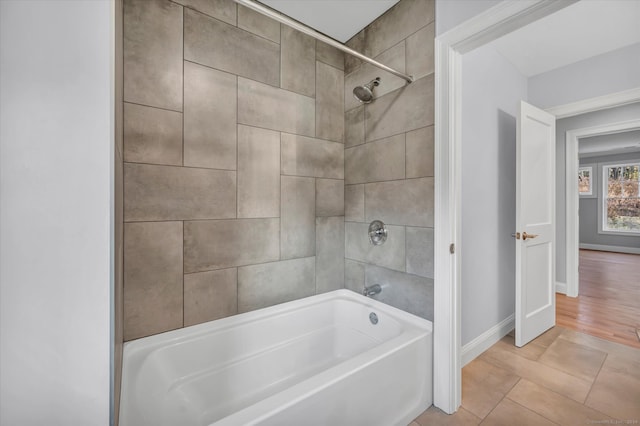 bathroom featuring tile patterned flooring and tiled shower / bath