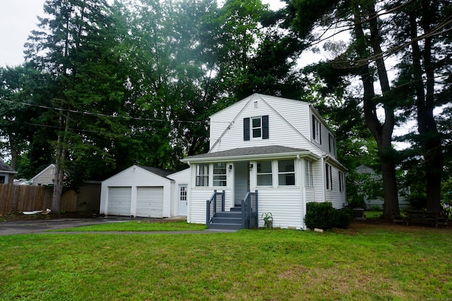 view of front of house with a front yard, an outdoor structure, and a garage