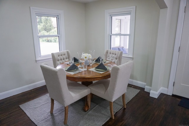 dining space with dark hardwood / wood-style flooring