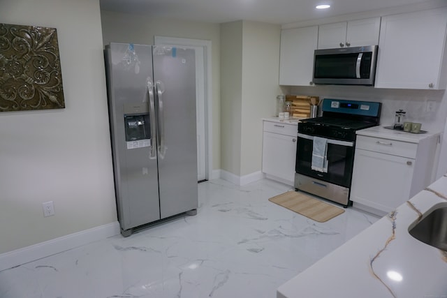 kitchen featuring white cabinetry and appliances with stainless steel finishes