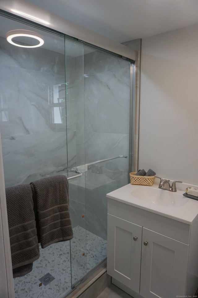 bathroom featuring vanity and a shower with shower door