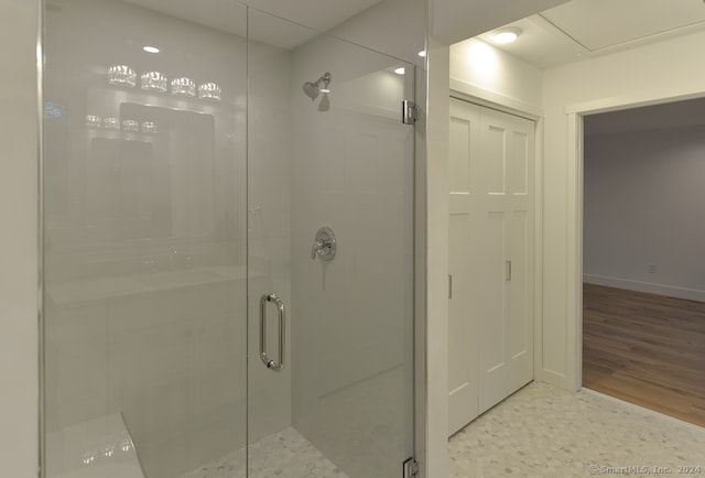 bathroom featuring wood-type flooring and a shower with door