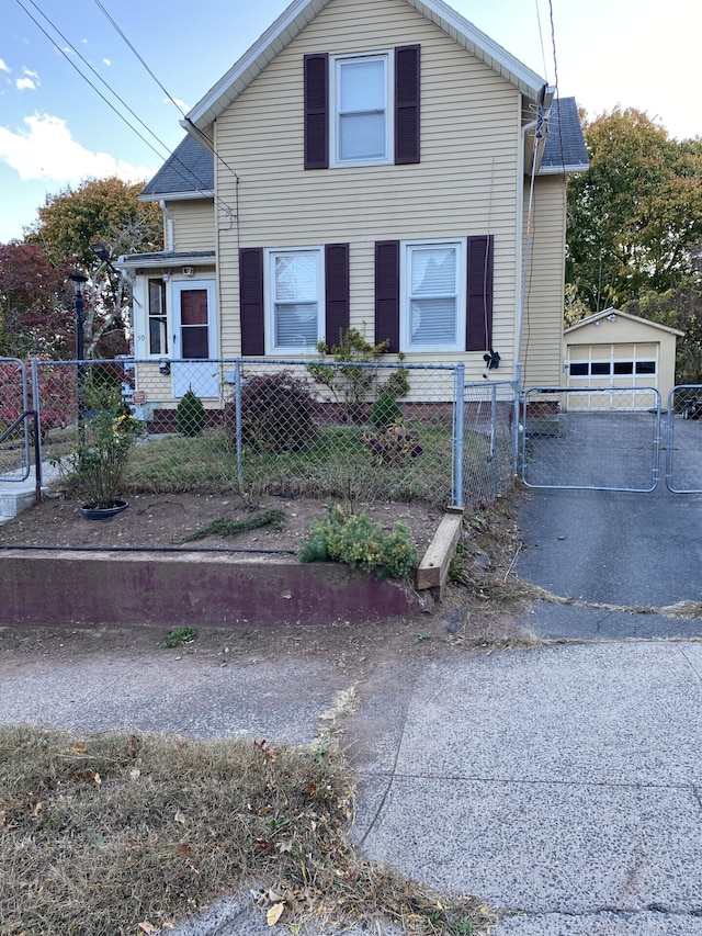 view of front facade featuring a garage and an outdoor structure