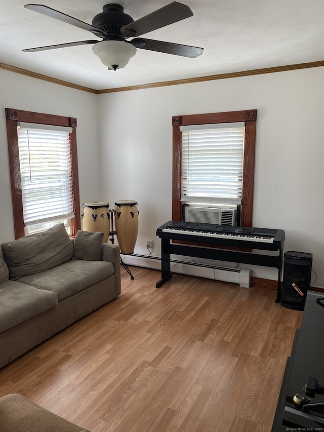 living room featuring baseboard heating, light wood-type flooring, ornamental molding, and cooling unit