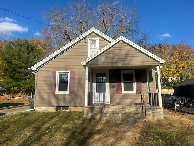 bungalow-style home featuring a front yard and a porch