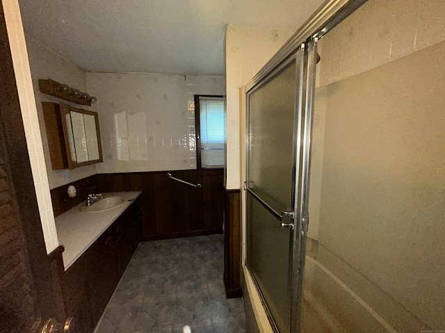 bathroom with sink and an enclosed shower