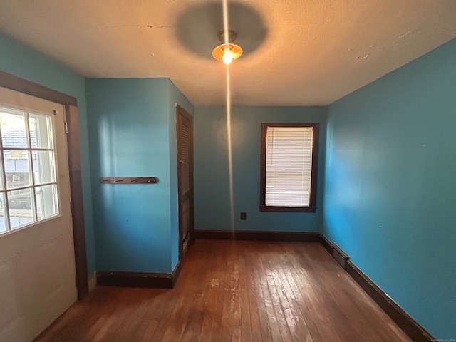 unfurnished bedroom with dark hardwood / wood-style floors and a closet