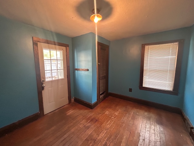 doorway to outside featuring ceiling fan and dark hardwood / wood-style flooring