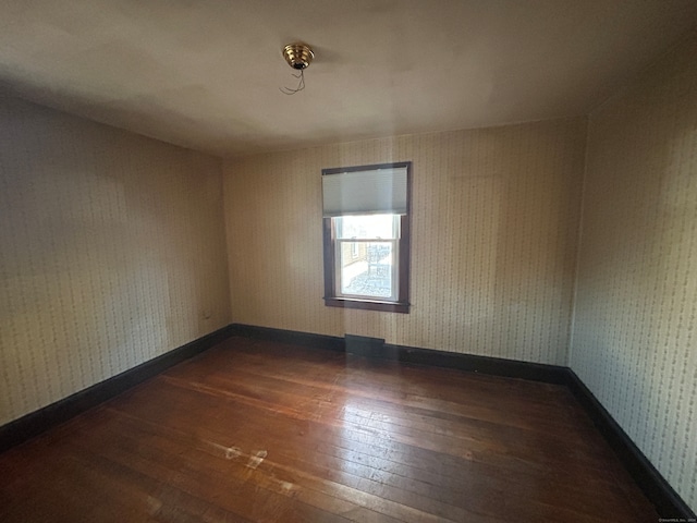 spare room featuring dark hardwood / wood-style flooring