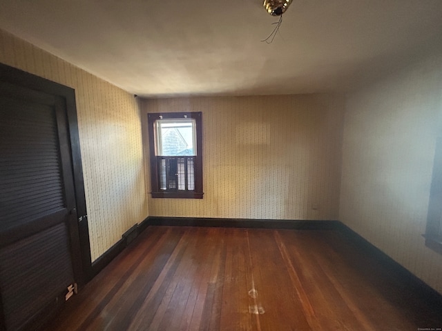 empty room featuring dark hardwood / wood-style floors