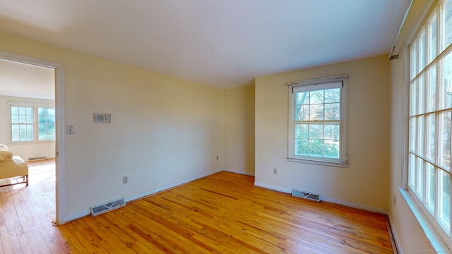 empty room with light hardwood / wood-style flooring