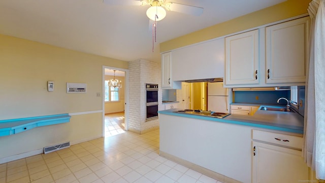 kitchen with white cabinets, white appliances, ceiling fan with notable chandelier, and sink