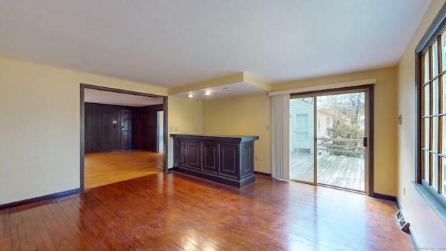 unfurnished room with wood-type flooring