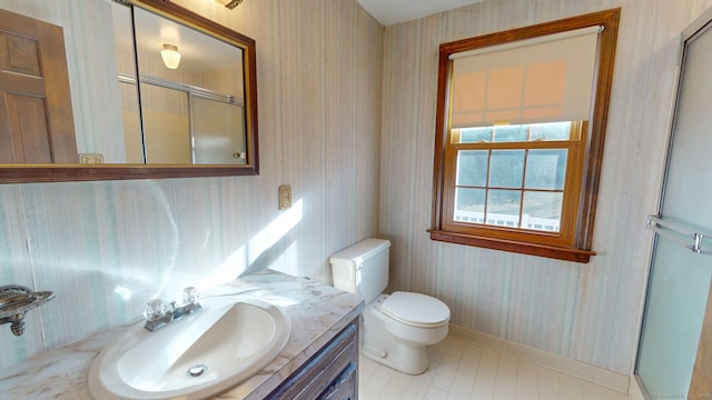 bathroom with toilet, vanity, tile patterned floors, and an enclosed shower