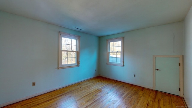 spare room featuring light hardwood / wood-style flooring