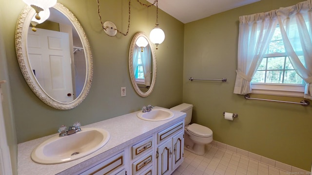 bathroom featuring tile patterned floors, vanity, and toilet