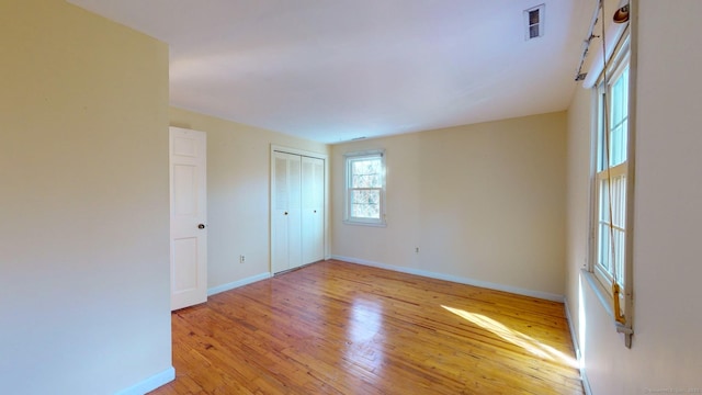 spare room featuring light hardwood / wood-style floors