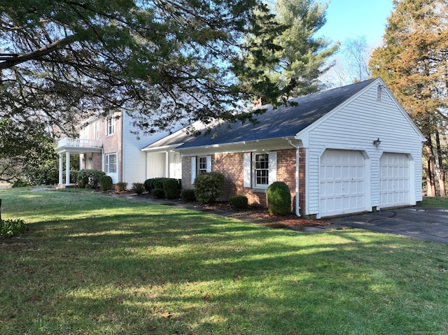 view of front of property featuring a garage and a front lawn