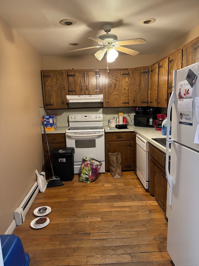 kitchen featuring ceiling fan, white appliances, a baseboard radiator, and light hardwood / wood-style flooring