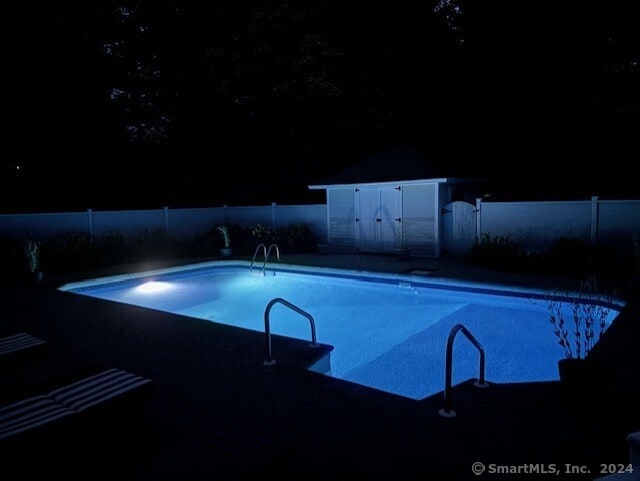 view of pool at night