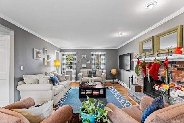 living room with a brick fireplace, wood-type flooring, a baseboard heating unit, and ornamental molding