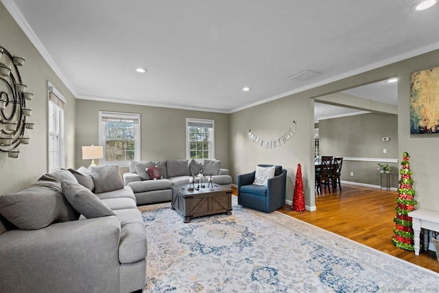 living room with hardwood / wood-style floors and ornamental molding