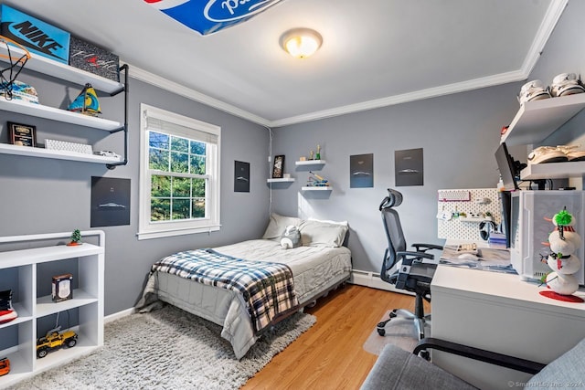 bedroom with baseboard heating, crown molding, and light hardwood / wood-style floors