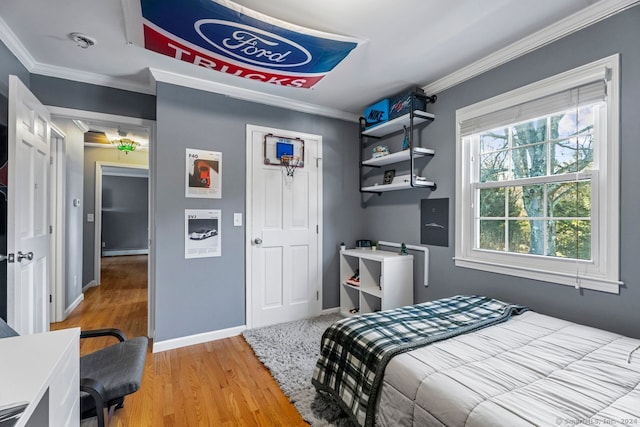 bedroom featuring crown molding and hardwood / wood-style flooring