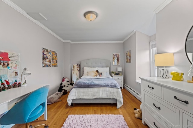 bedroom with ornamental molding, light hardwood / wood-style floors, and a baseboard heating unit