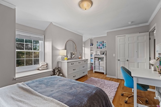 bedroom featuring crown molding and light hardwood / wood-style floors