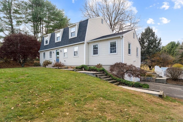 rear view of property with a lawn