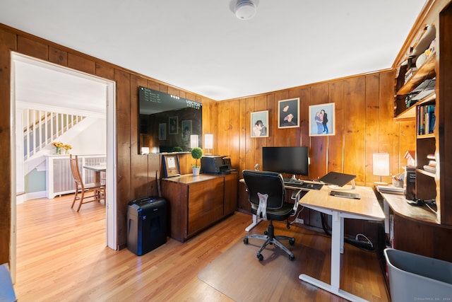 office area featuring wooden walls and light hardwood / wood-style floors