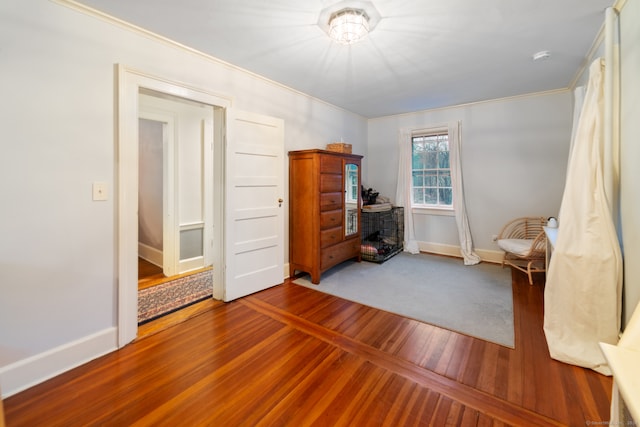 interior space featuring hardwood / wood-style floors and ornamental molding