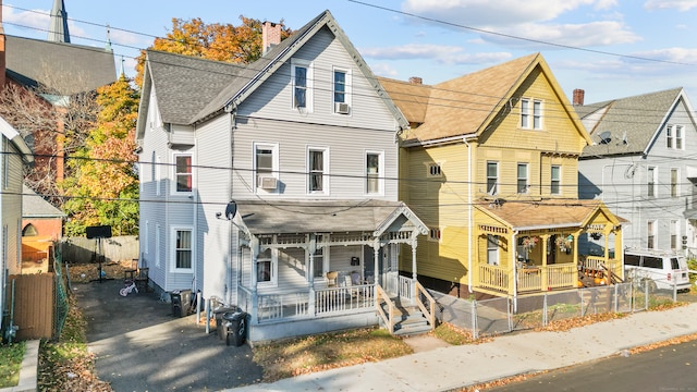 view of front facade with covered porch and cooling unit