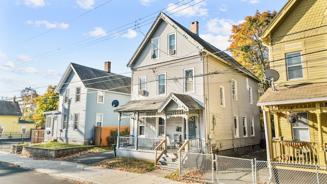 front of property with cooling unit and covered porch