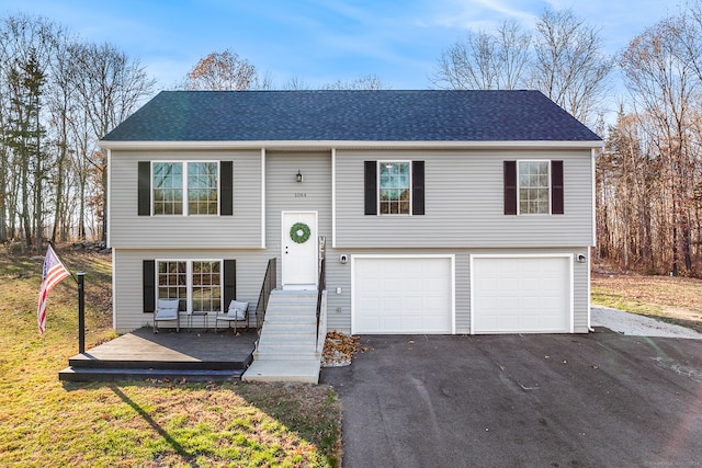 split foyer home featuring a porch and a garage