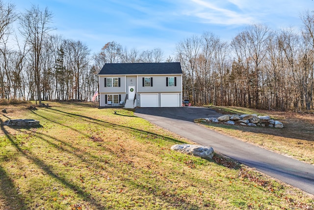 bi-level home with a garage and a front yard