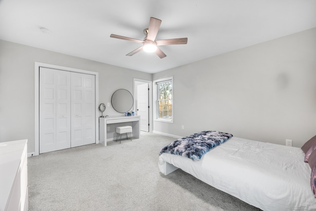 bedroom featuring light carpet, a closet, and ceiling fan