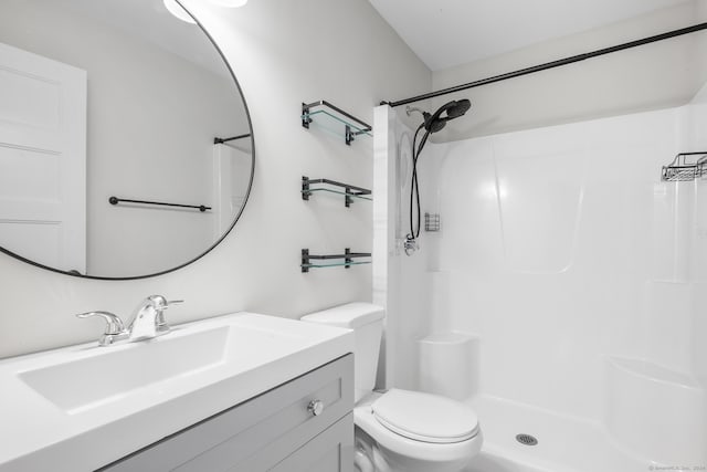 bathroom with vanity, toilet, and walk in shower