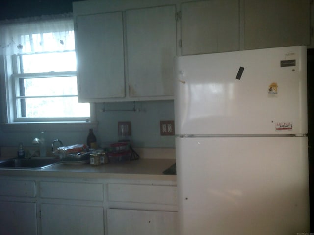 kitchen featuring white fridge and sink