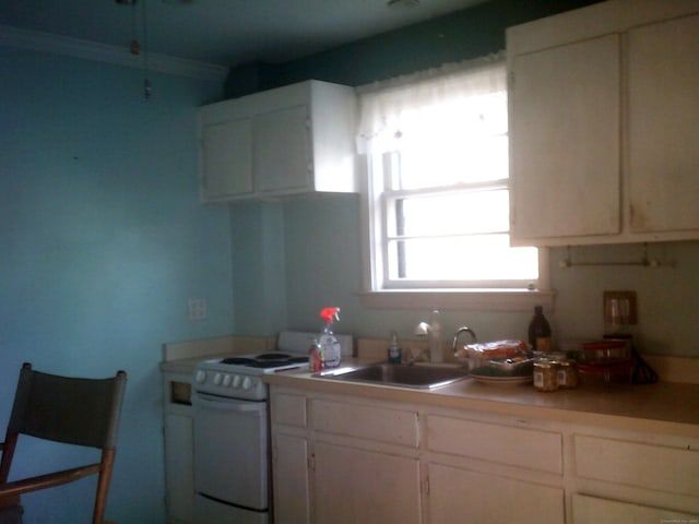 kitchen featuring white cabinets, white range, ornamental molding, and sink