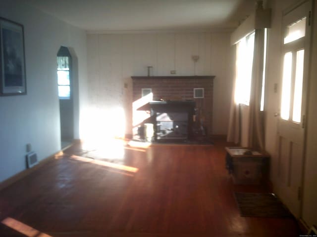 unfurnished living room with hardwood / wood-style flooring