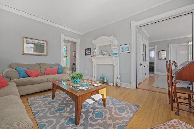 living room with light wood-type flooring and ornamental molding