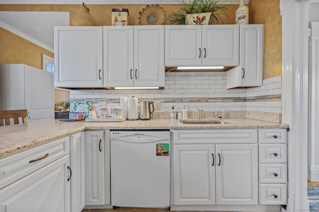 kitchen with white cabinetry, dishwasher, light stone countertops, sink, and tasteful backsplash