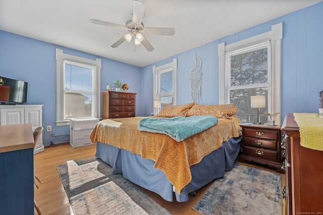 bedroom with ceiling fan and light wood-type flooring