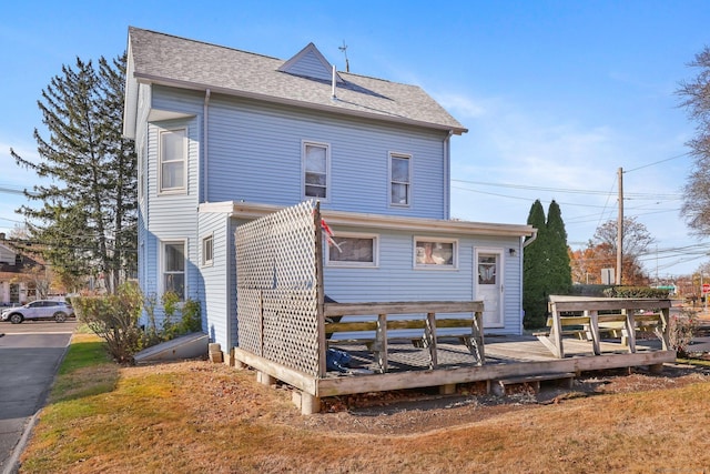 back of house featuring a wooden deck