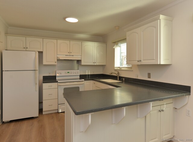 kitchen featuring white appliances, white cabinets, sink, ornamental molding, and kitchen peninsula